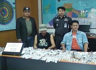 Prapat Sainai and Sakchai Pungen, seated, are held for questioning at Pattaya Police Station.